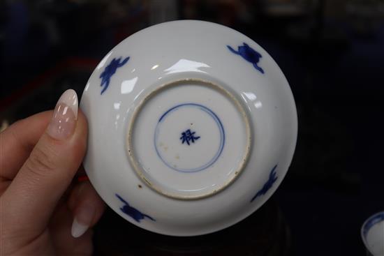 An 18th century Chinese blue and white tea bowl and saucer, and a similar bowl and two hardwood stands